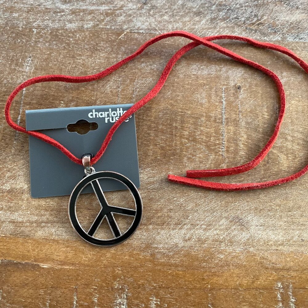 Never used enamel Peace Sign Necklace on a red cord.